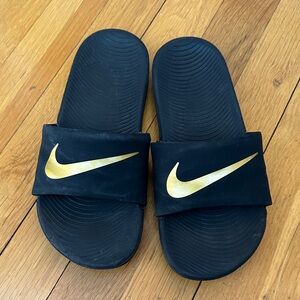 Nike Black Slides with Gold Swoosh